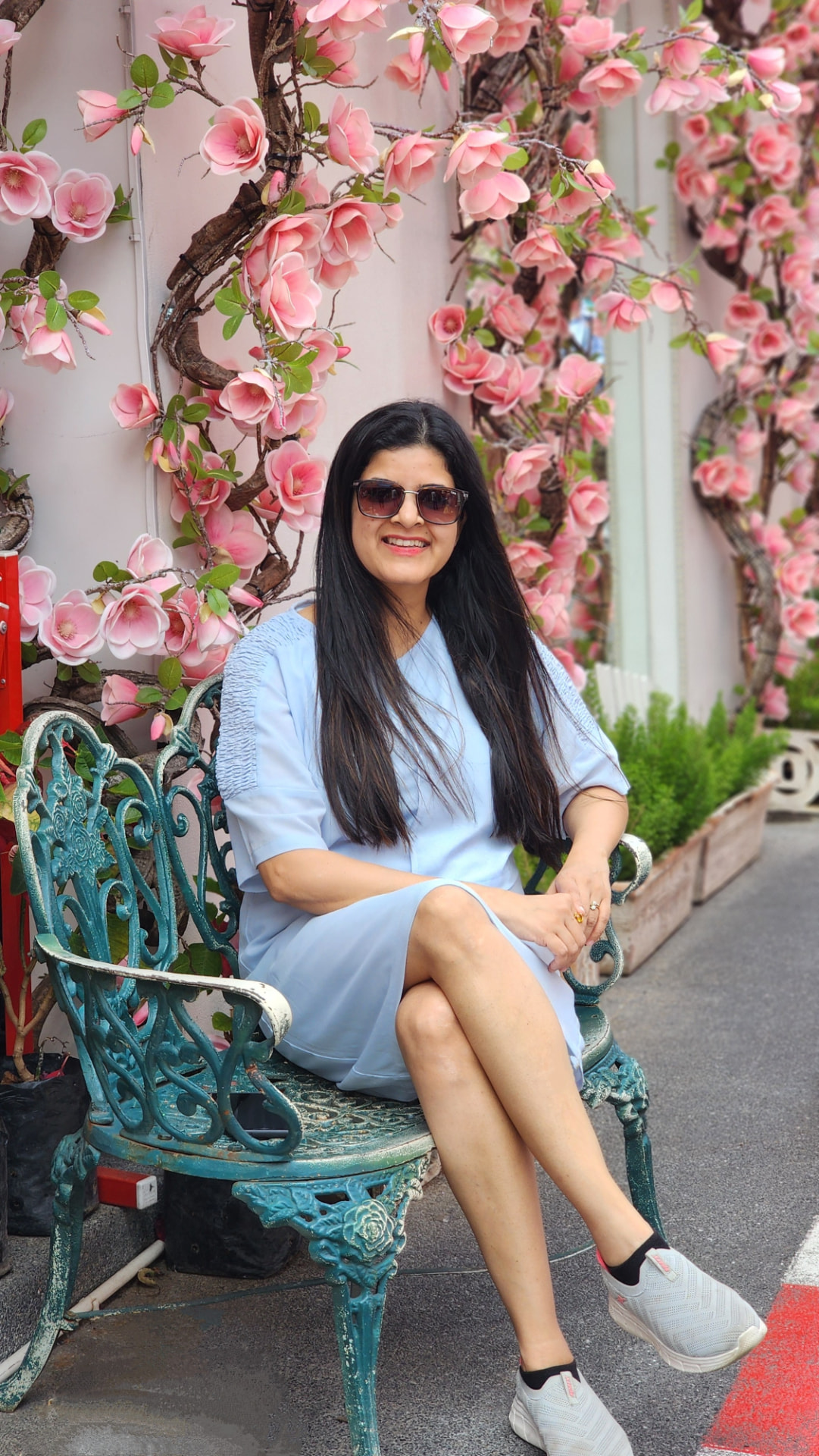 Dr. Supriya Joshi seated among flowering branches